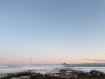 Scenic view of snow covered field against clear sky