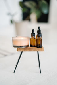 Close-up of essential oils on stool