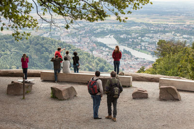 Rear view of people enjoying view of city from observation point