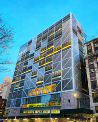 Low angle view of modern building against blue sky