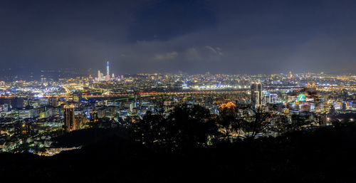 High angle view of city lit up at night