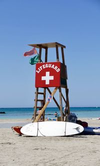 Lifeguard hut on beach against clear sky