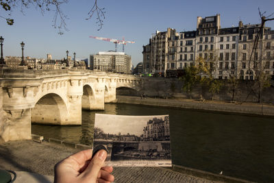 Low angle view of bridge over river in city