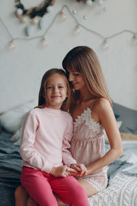 Mother and girl sitting on floor