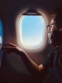 Portrait of woman seen through airplane window