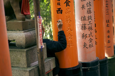 Midsection of man with text at temple