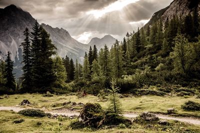 Scenic view of mountains against cloudy sky