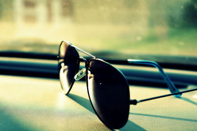 Close-up of sunglasses on dashboard