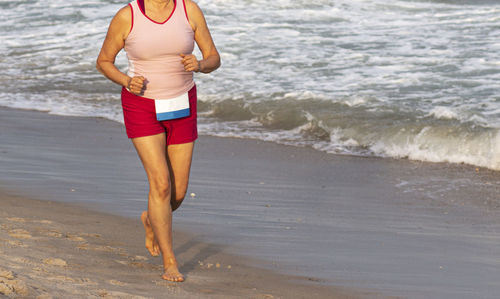 Full length of woman standing on beach