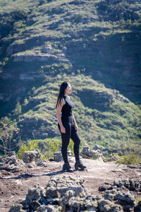 Full length of young woman standing on land