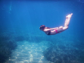 Full length of woman swimming undersea