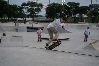 Rear view of people skateboarding on skateboard