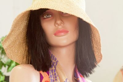 Close-up of wig and hat on mannequin