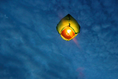 A chinese lantern flies high into the night sky. making wishes when releasing