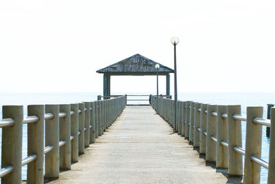 Pier over sea against clear sky