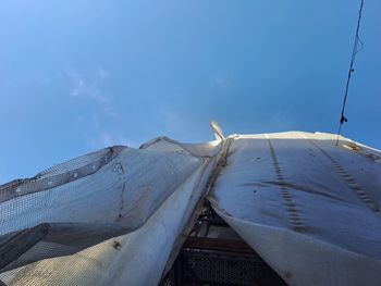 Low angle view of ship against clear blue sky