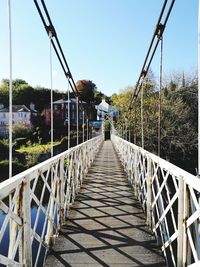 View of footbridge against clear sky