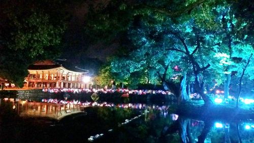 Reflection of illuminated building in water at night