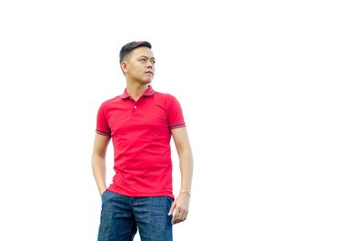 Young man standing against white background