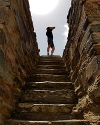 Low angle view of man on staircase against sky