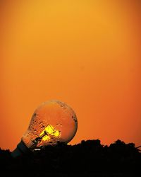 Silhouette plants against clear sky during sunset