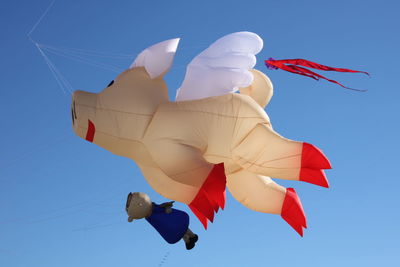 Low angle view of kite against clear blue sky