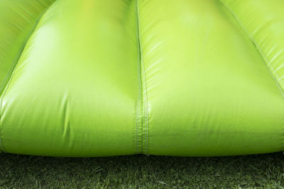 Green inflatable trampoline. obstacle course. details of amusement park. rubber material is green.