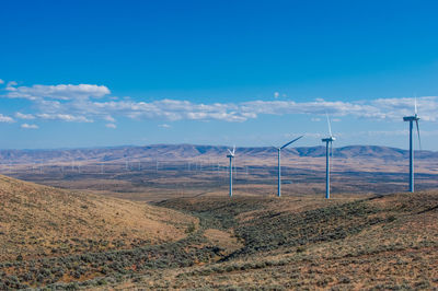 Scenic view of a valley of wind turbines 