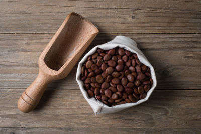 Directly above shot of beans with wooden spoon on table