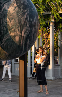 Side view of two women standing at balloon