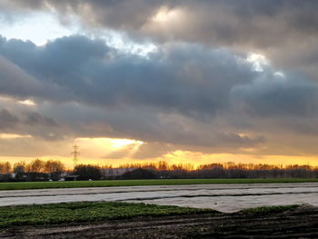 Scenic view of field against sky during sunset