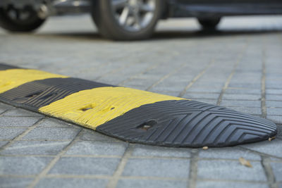 Close-up of yellow bicycle on footpath