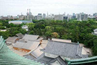 High angle view of buildings and trees against sky