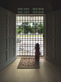 Woman standing by window