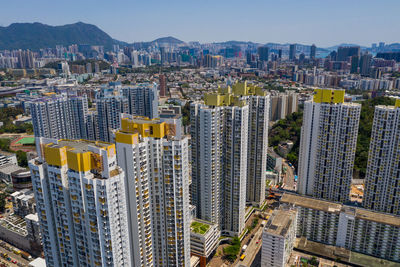 High angle view of modern buildings in city against sky