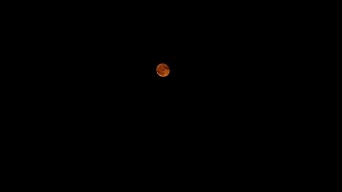 Low angle view of moon against clear sky at night