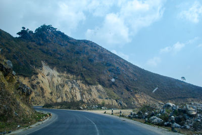 Road amidst mountains against sky