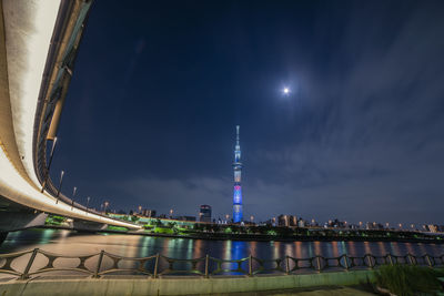 Illuminated cityscape against sky at night