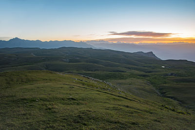 Scenic view of landscape against sky during sunset