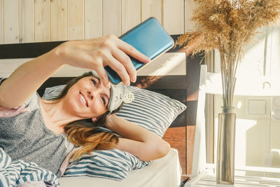 Portrait of young woman using mobile phone