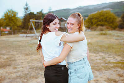 Happy friends standing on land