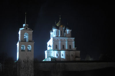 Low angle view of illuminated building against sky at night