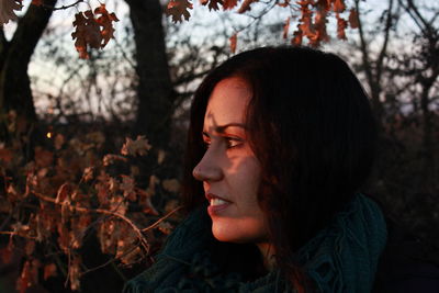 Close-up portrait of young woman with autumn leaves