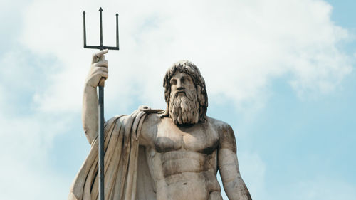 Low angle view of statue against sky