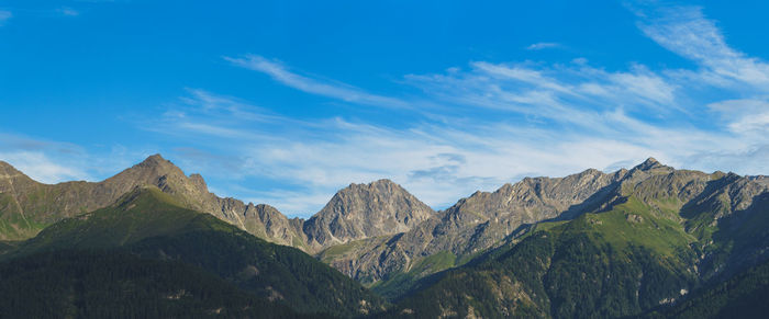 Scenic view of mountains against cloudy sky