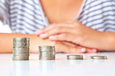 Close-up of hand holding stack of objects on table