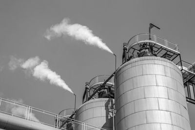 Low angle view of smoke stack against sky