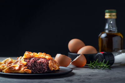 Close-up of food on table against black background