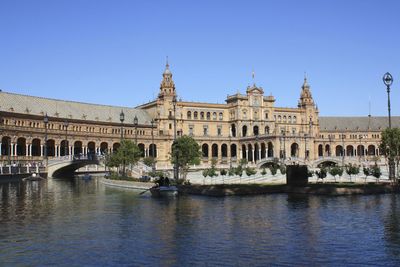 Buildings in city against clear sky