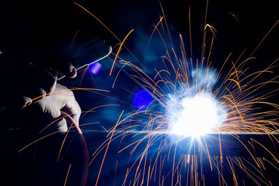 Low angle view of firework display at night